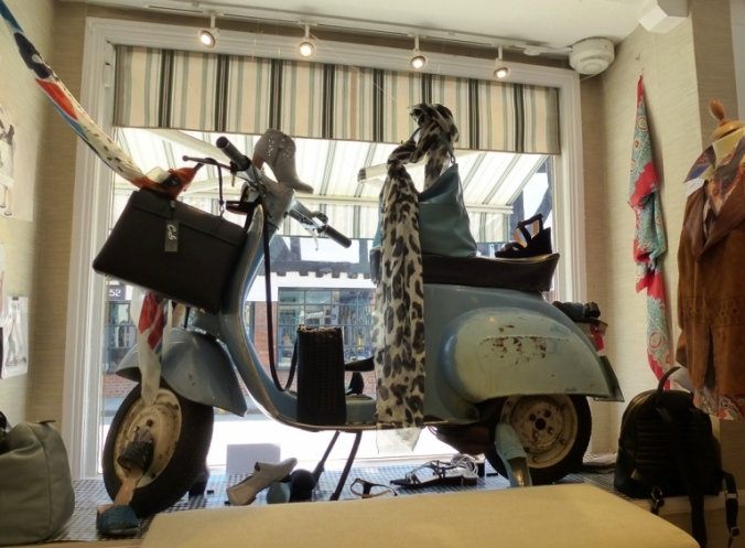 From the inside looking out: a venerable Vespa forms part of the window display at Raffinée, the High Street shoe shop in Salisbury.